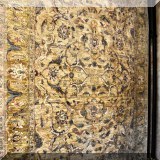 R18. Handknotted Oriental rug in shades of gold and green.